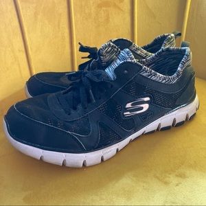 Skechers relaxed fit sneakers in black and white